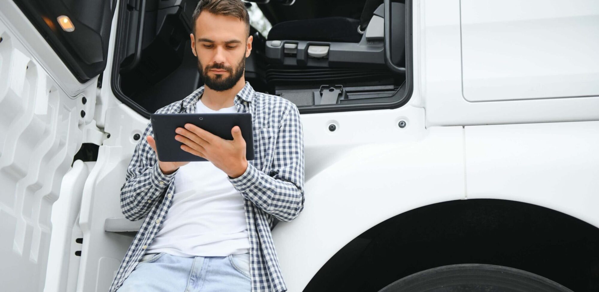 How technology is transforming the trucking industry men driver near lorry truck man owner truck driver he5z5mc